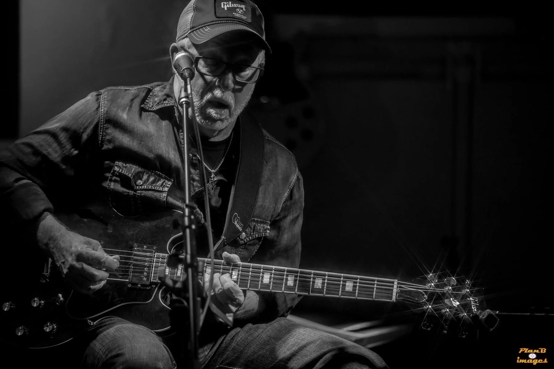 Greg Mebs performing in black and white